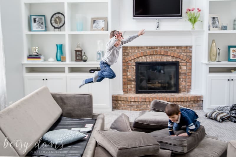 child jumping from couch
