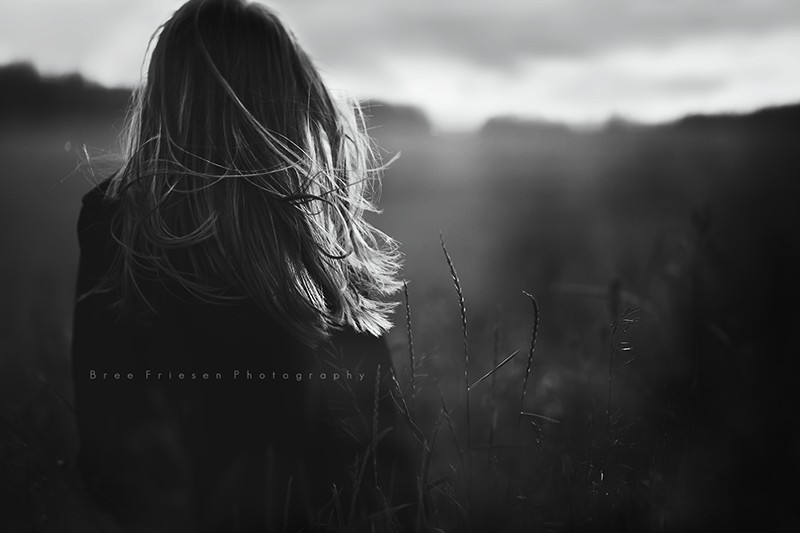 black and white photo of woman in field