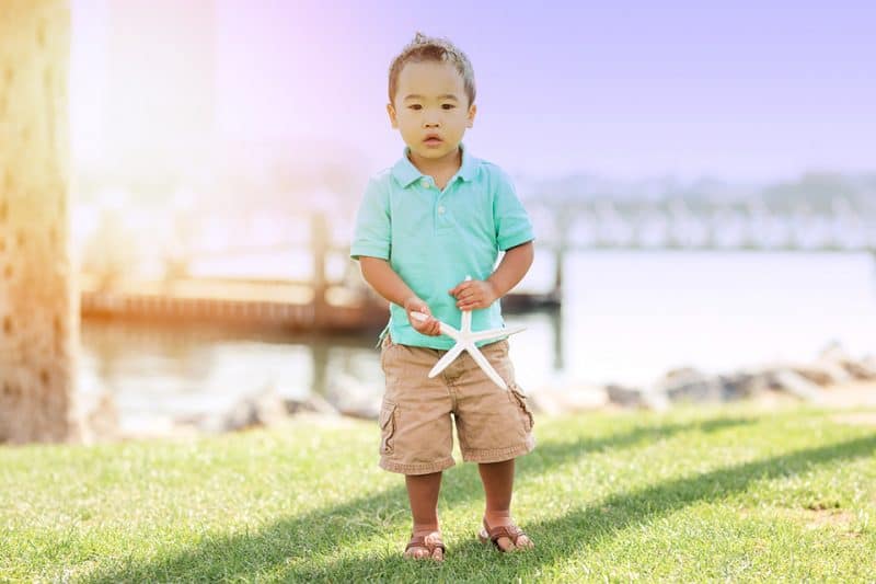 boy holding starfish