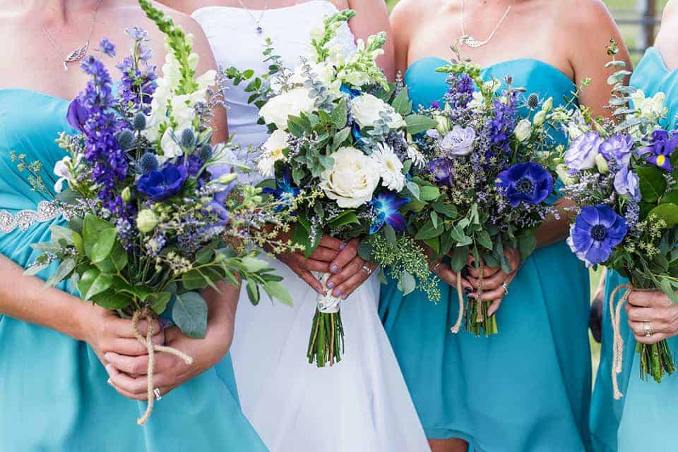bridesmaids holding flower bouquets 