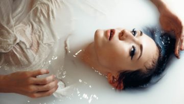 woman laying in bath
