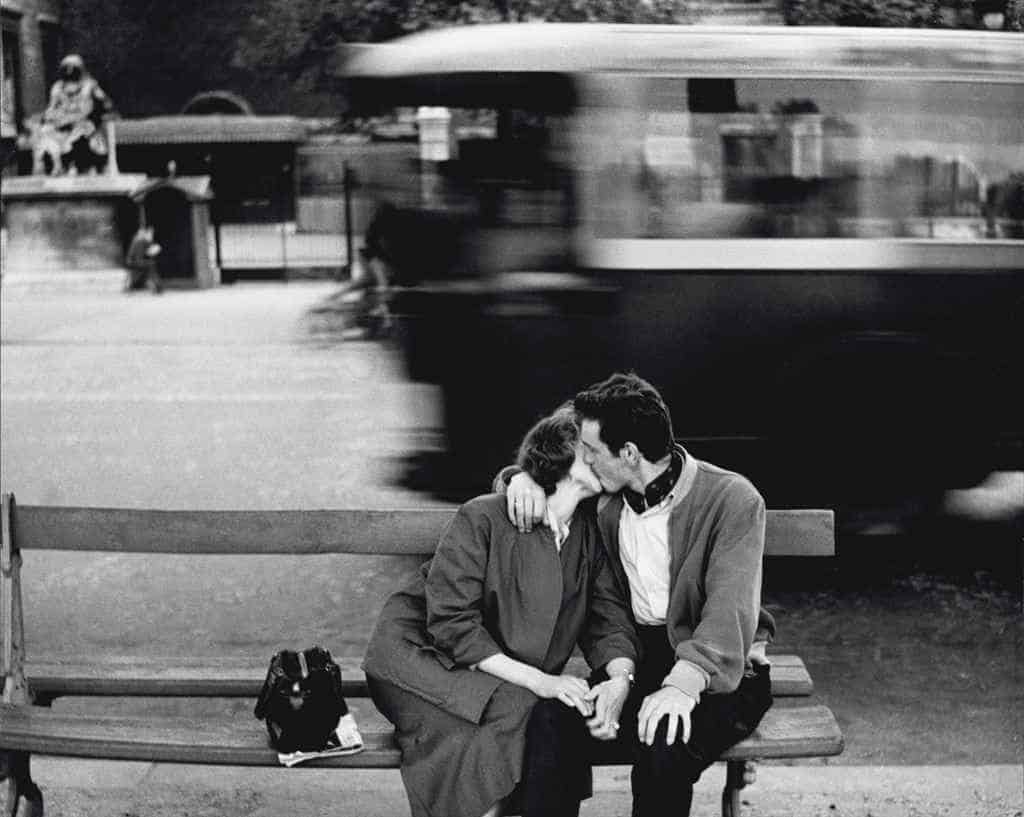 couple kissing with old street car in the background