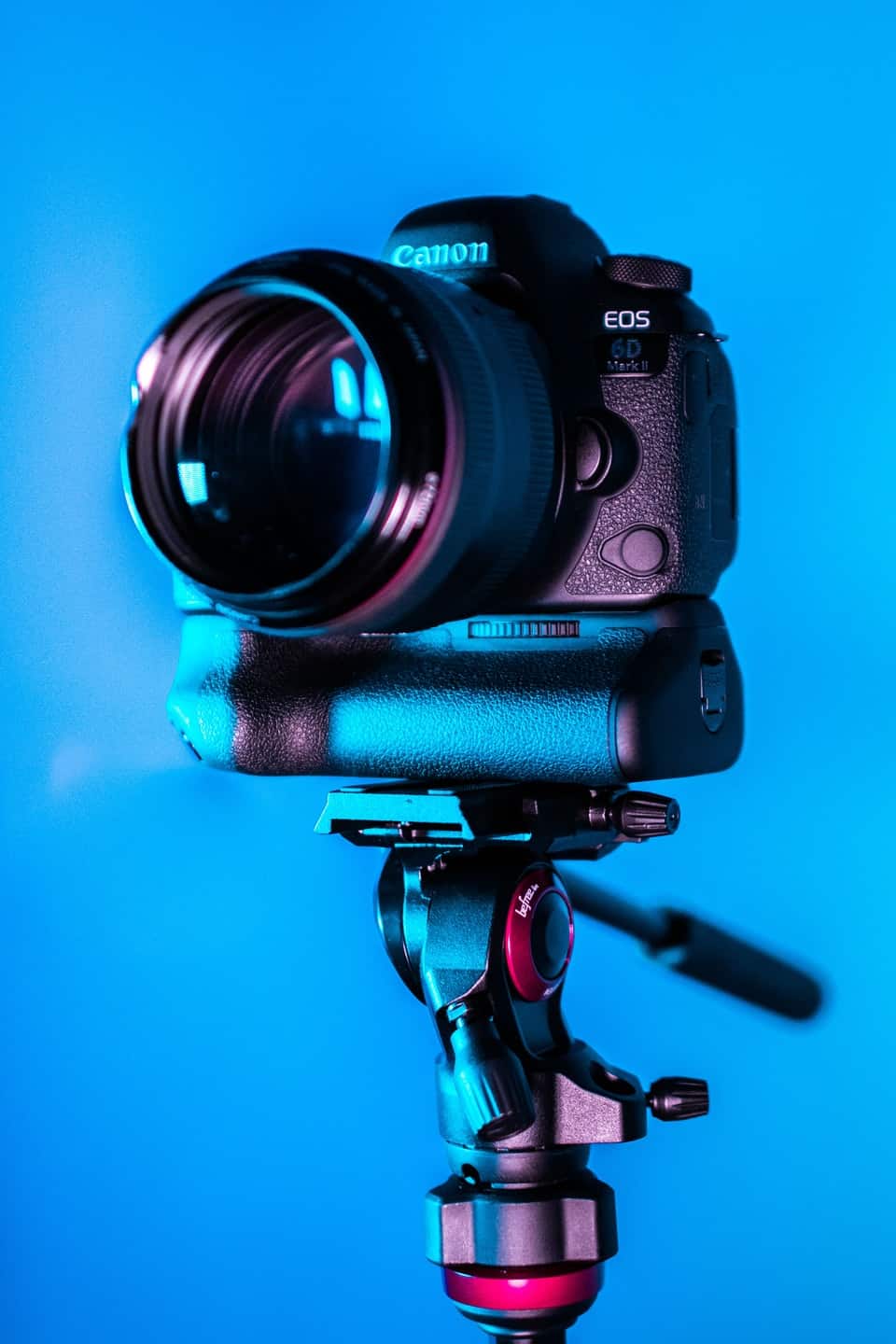 Canon camera on tripod with blue background