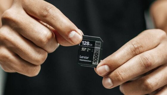 man in black holding SD card