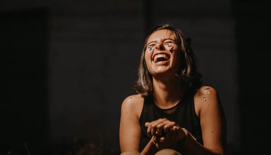 girl laughing with eyes closed