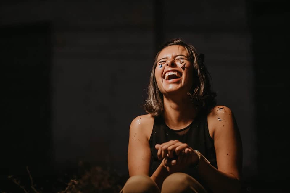 girl laughing with eyes closed
