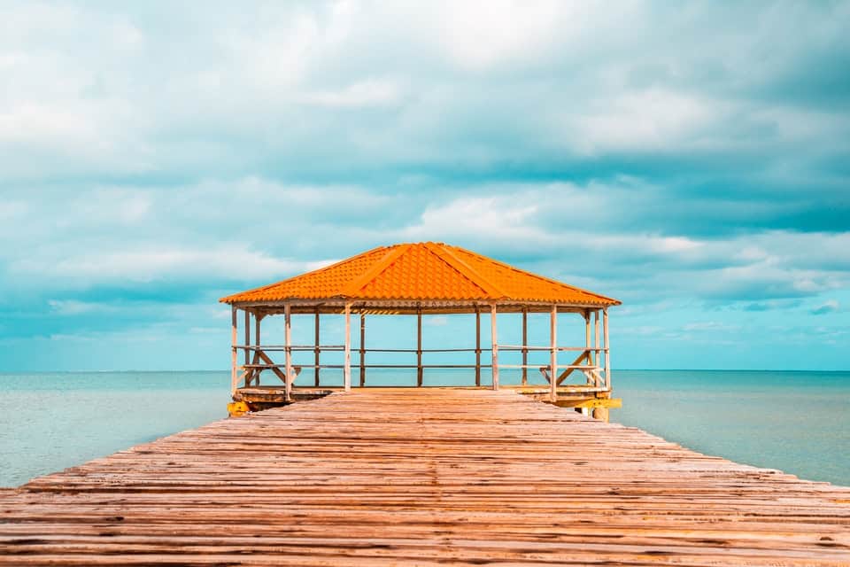 orange hut in front of sky blue beach 