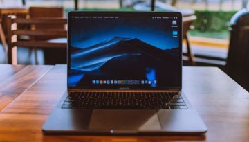 open laptop on brown desk
