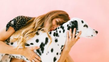 woman hugging Dalmatian dog