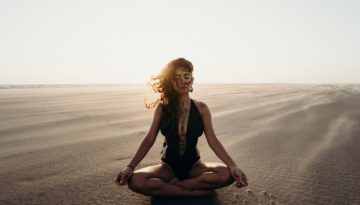 woman doing yoga in desert