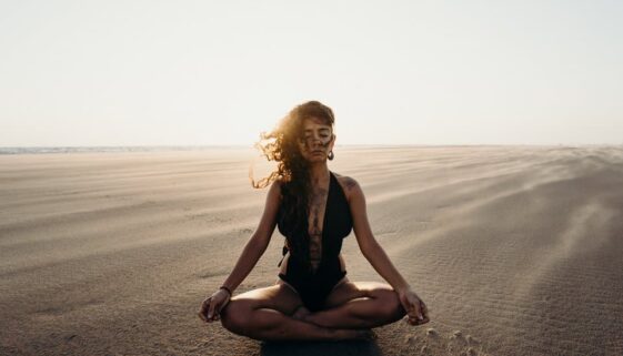 woman doing yoga in desert