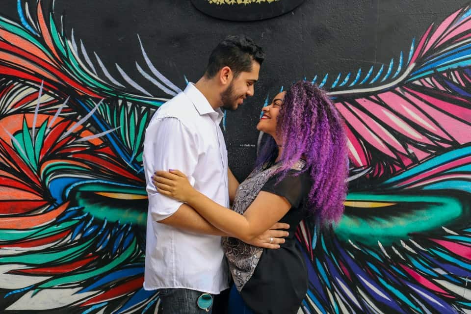 couple in front of mural