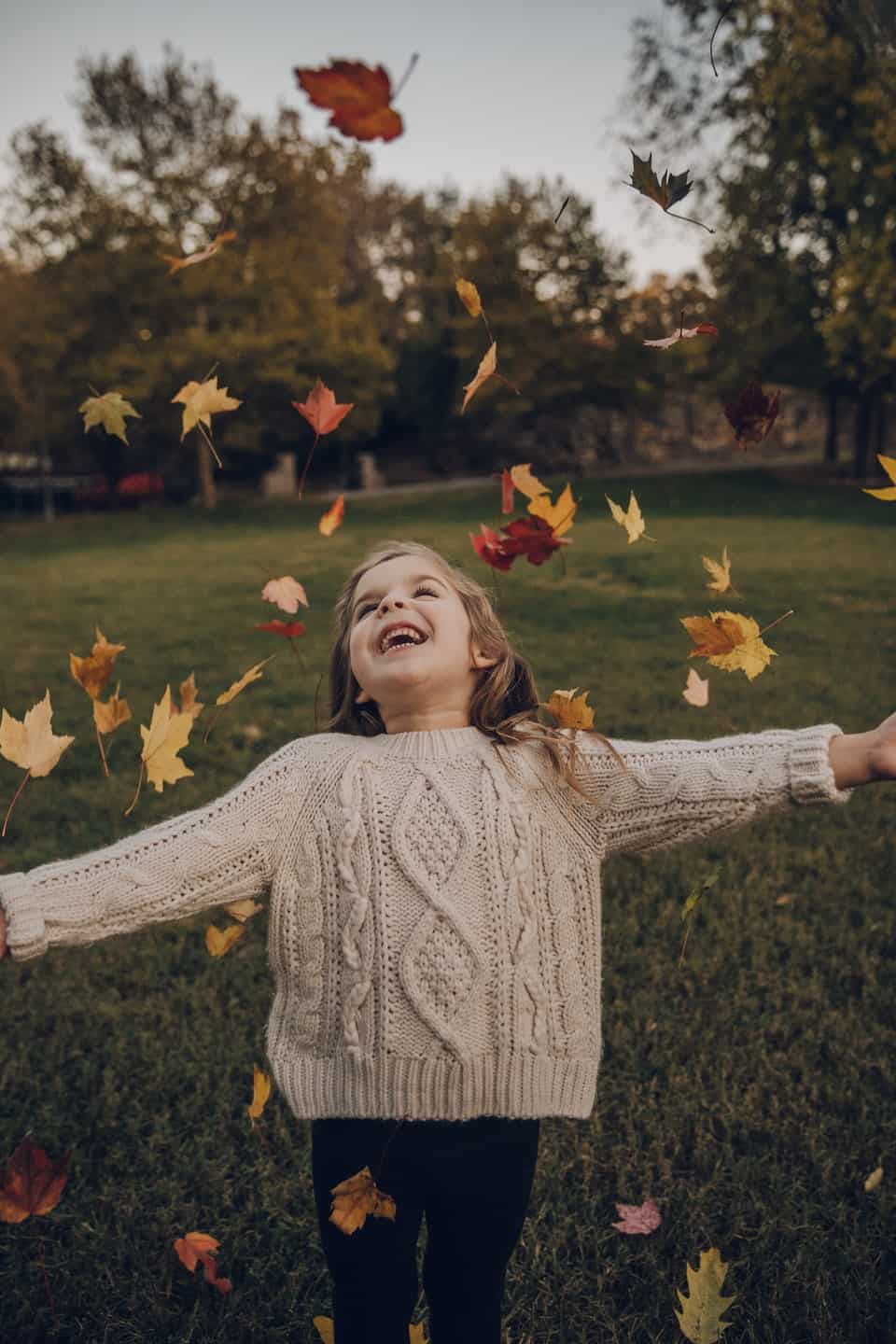 girl in fall leaves