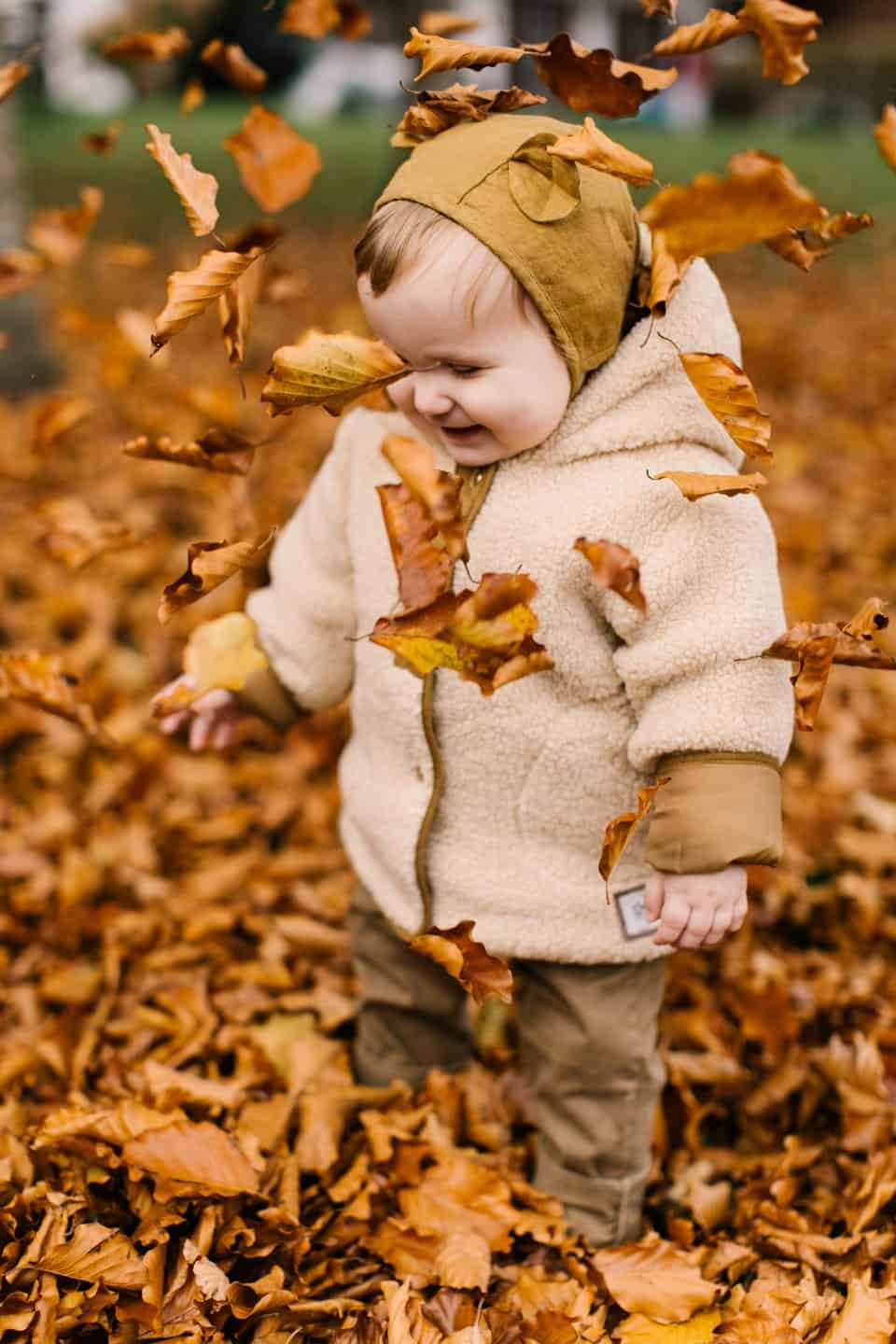 toddler in leaves